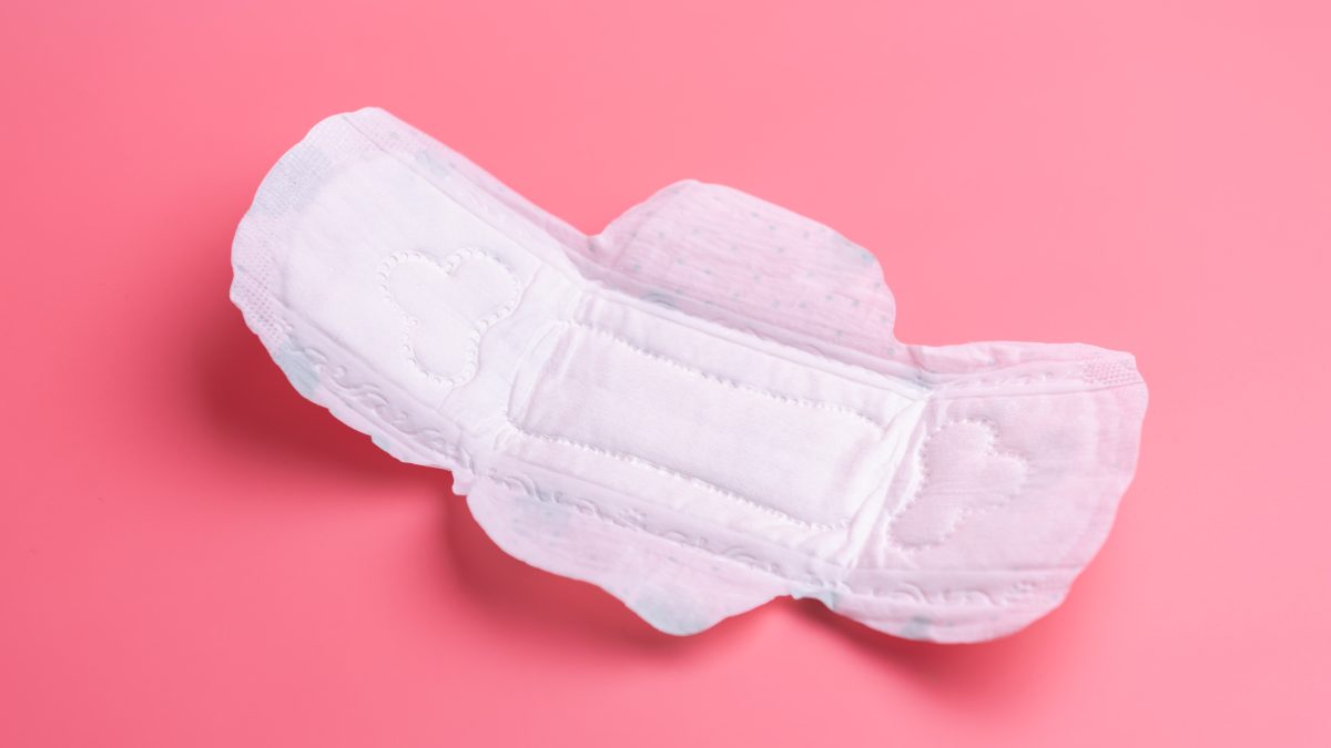 close up of woman's sanitary pad on pink
