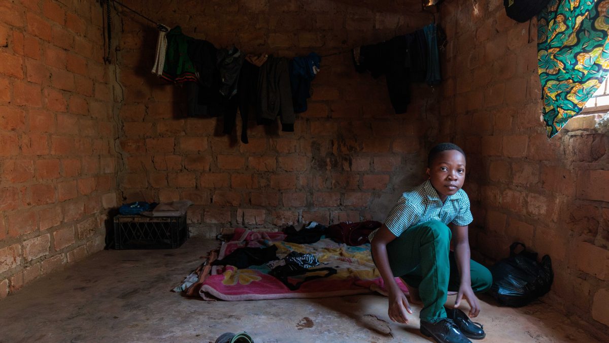Lumbwe Lungu gets dressed into his school uniform